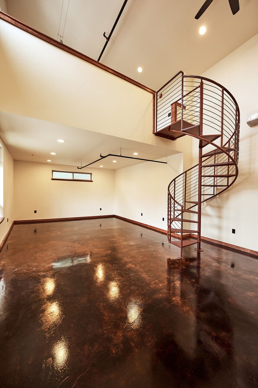 Interior of office building with spiral staircase leading to upstairs loft
