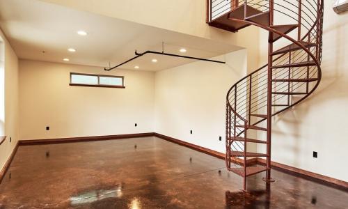 Interior of office building with spiral staircase leading to upstairs loft